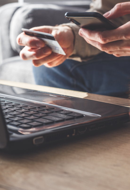 mans-hands-holding-a-credit-card-and-usi